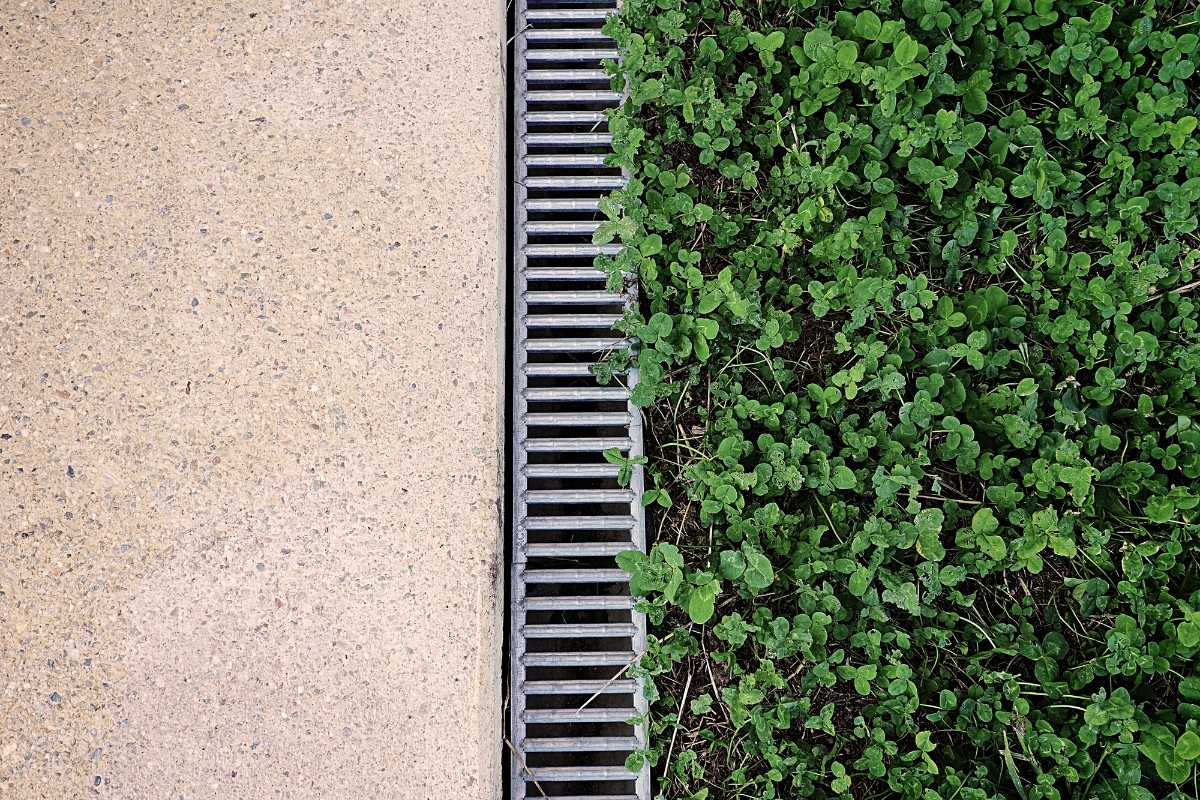 Concrete patio drainage grates for effective water flow