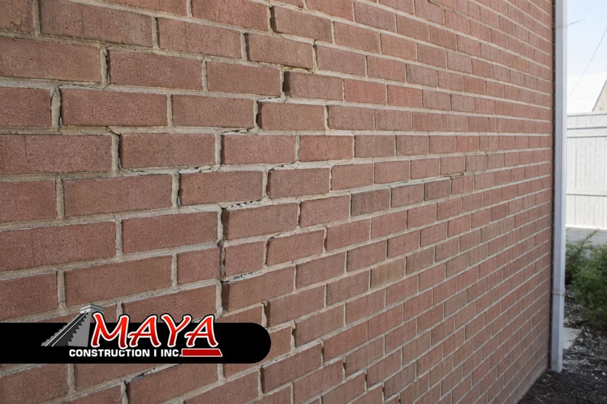 Bulging brick wall warning signs on an exterior masonry wall