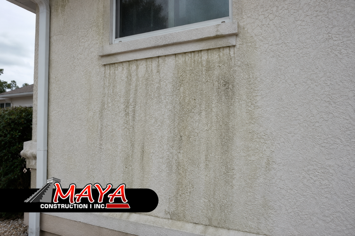 Stucco staining causes visible on a residential exterior wall